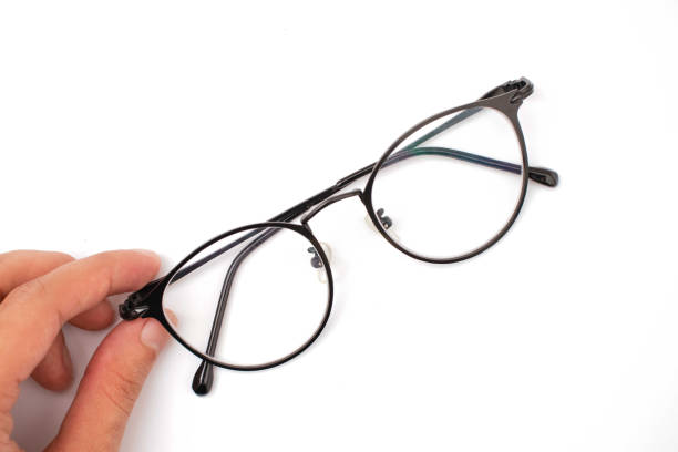 istock hand holding glasses on a white background 1350883764