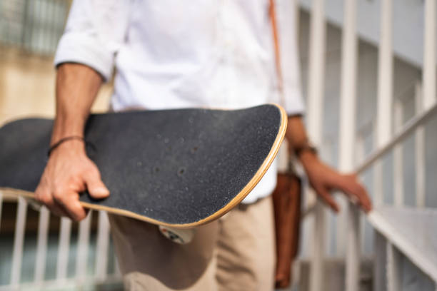 istock Unrecognizable man, going down the stairs while holding a skateboard 1350883797
