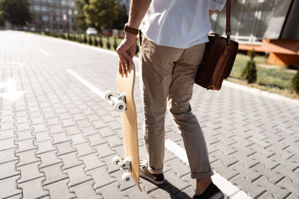 istock Alternative and urban unrecognizable man with skateboard and messenger bag 1350883826