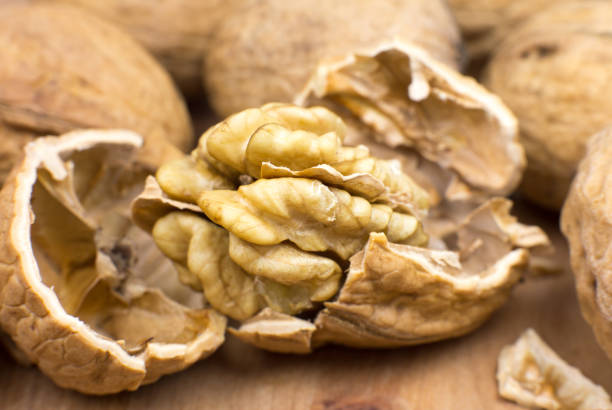 istock Crushed Walnut on the wood background. Close up. 1350884515