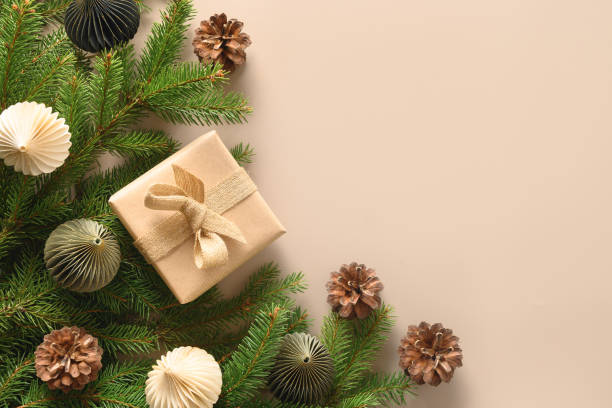 istock Christmas craft eco gift and festive composition with pine cones on beige background. 1350885974