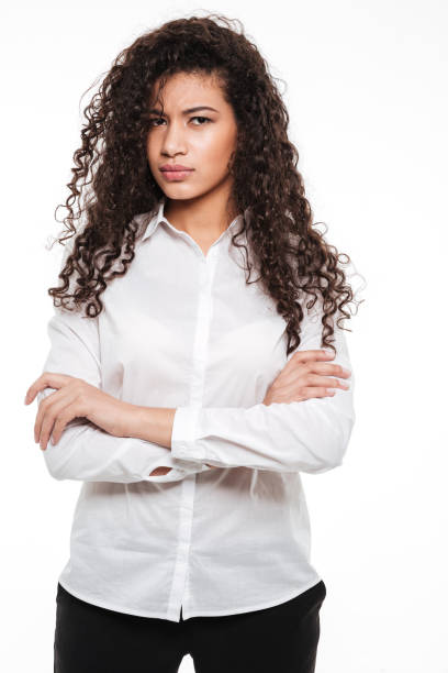 istock Angry young curly african lady posing over white background. 1350885989