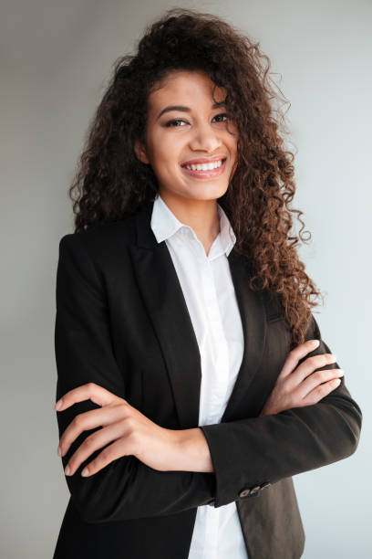 istock African business lady standing over grey background. 1350886372