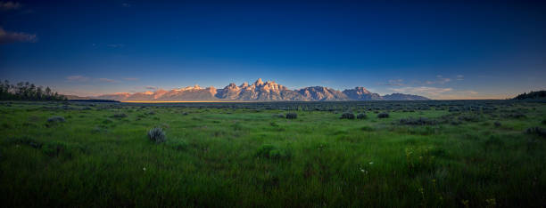 Panoramic view of early sun rays on the Grand Teton mountain range.