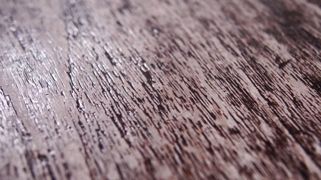 Textured wood material illuminated by moving light