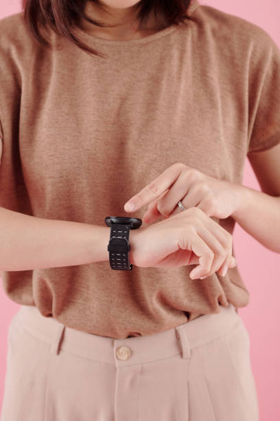 istock Wwoman Pointing at Smartwatch 1350891412