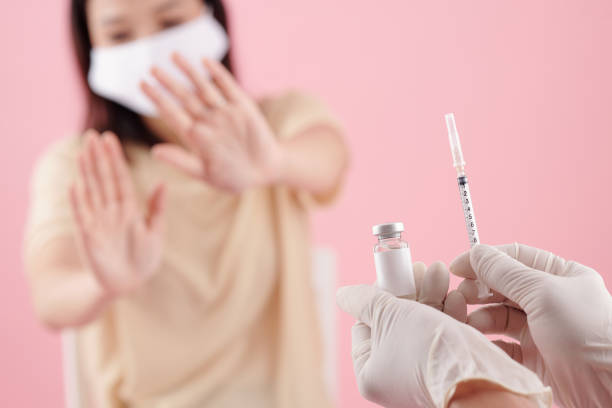 istock Doctor Offering Vaccine to Scared Patient 1350892048