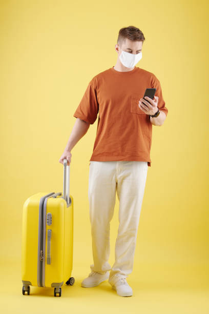 istock Tourist In Mask Checking Smartphone 1350892620