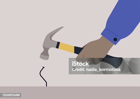 istock A hand holding a hammer and hitting a metal nail, a failure, manual work problems 1350892688
