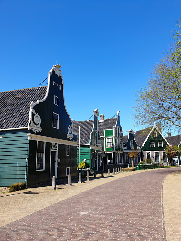 Empty, abandoned street in Zaanse Schans with clear blue sky