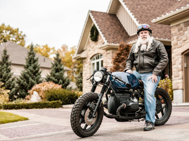 istock Senior man getting ready to ride his motorcycle 1350895326