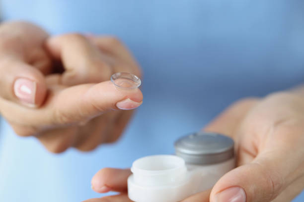 istock Soft contact lens on finger and storage box closeup 1350896107
