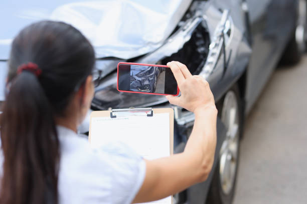 istock Insurance agent is filming damage to car closeup 1350896138