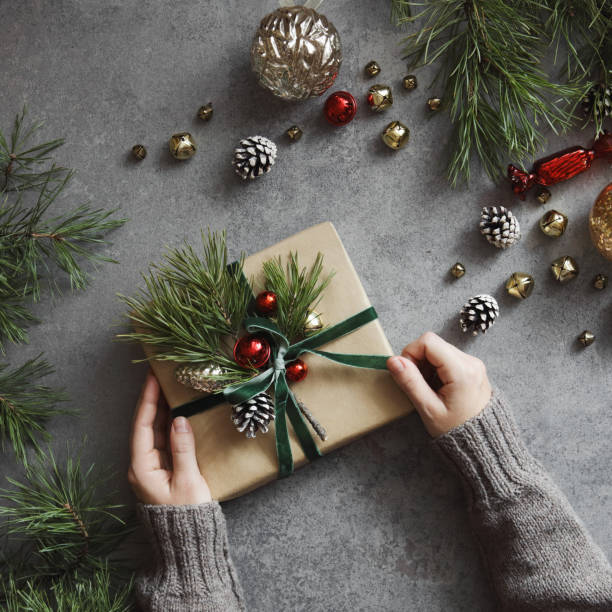 istock Woman decorating Christmas present 1350896680