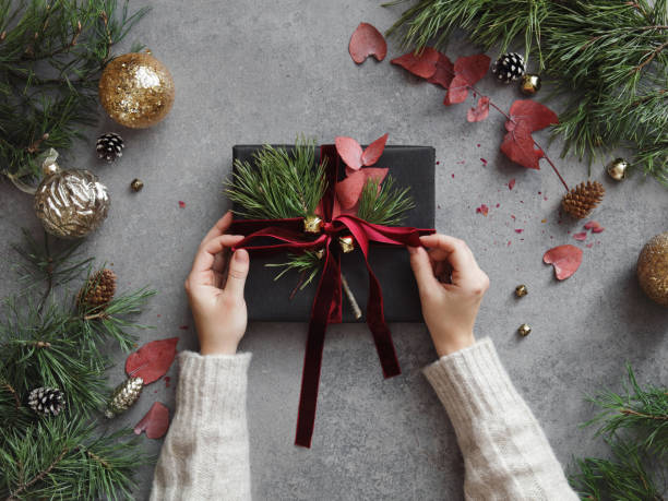 istock Woman decorating Christmas present 1350896728