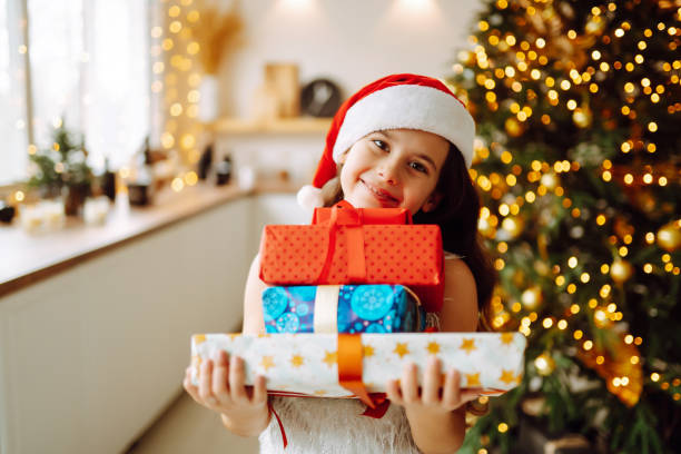 istock Happy smiling girl with christmas gift boxes. 1350897332