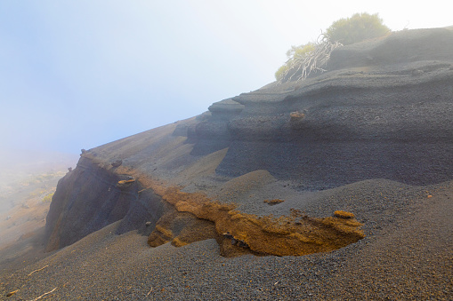 Teide's National Park, Volcanic Bombs embeded in Lapilli slopes.  Multicolors Volcanic Rocks. Mist coming and makig magnificent landscapes. Tenerife, Canary Islands
