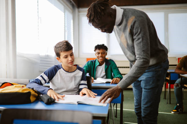 istock Teacher talking to the student in the classroom 1350900343