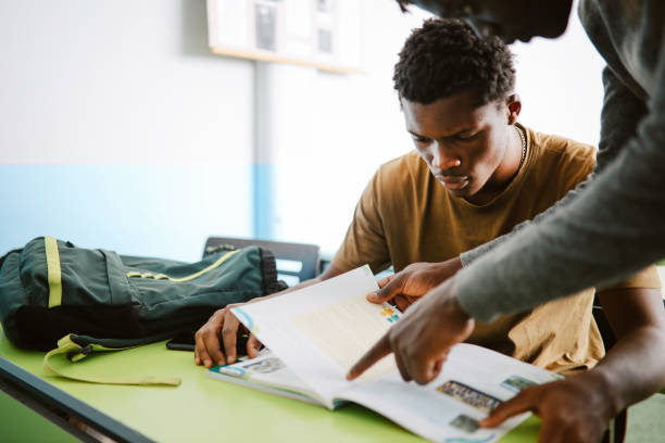 istock Teacher talking to the student in the classroom 1350900440
