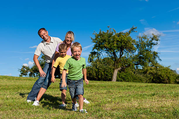istock Family with children playing on a meadow 135090119