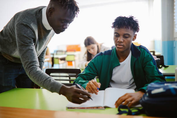 istock Teacher talking to the student in the classroom 1350901523