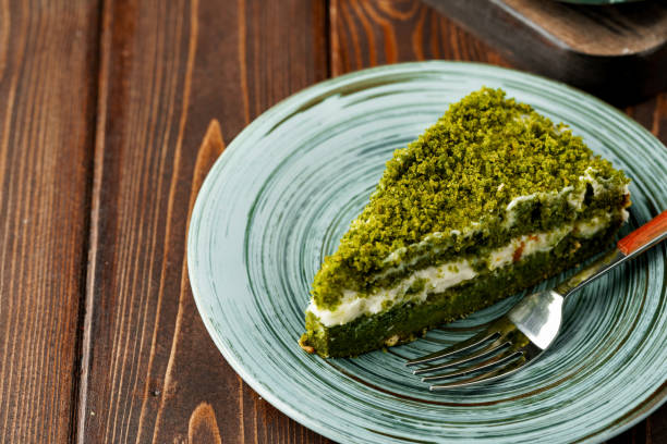 istock Piece of green spinach cake on plate 1350901538