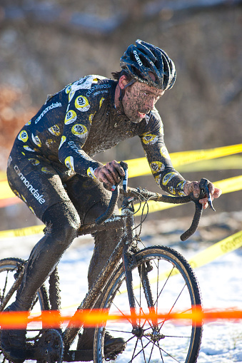 A man covered in mud competes in a winter cyclo-cross race in Kansas City, Kansas. Cyclo-Cross bikes are similar to road bikes but with bigger tires more suited to riding on rough terrain. (John Gibson Photo/Gibson Pictures)