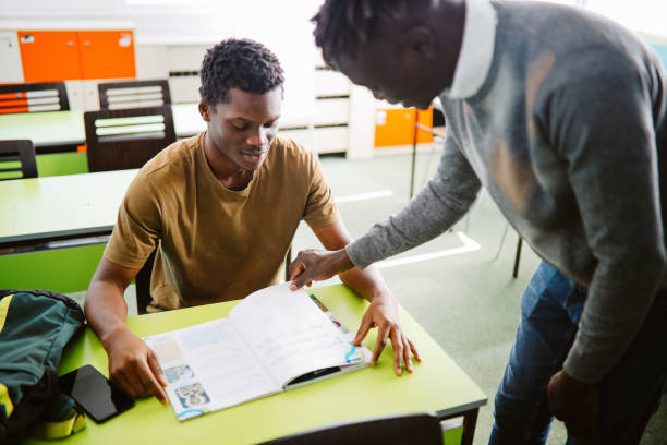 istock Teacher talking to the student in the classroom 1350901887