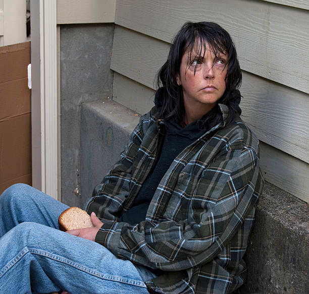 Homeless woman sitting in stair well. See similar images here: