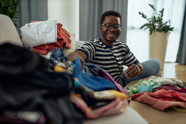 istock Black man donating some of his old clothes 1350905558