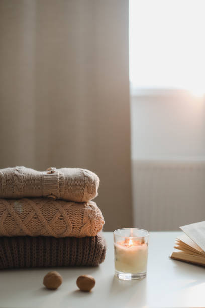 istock cozy home atmosphere and still life with coffee, candle and sweaters 1350906940