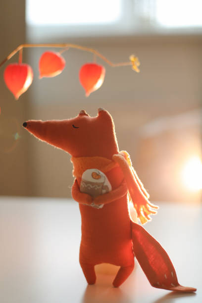 cozy autumn composition with a funny handmade toy fox