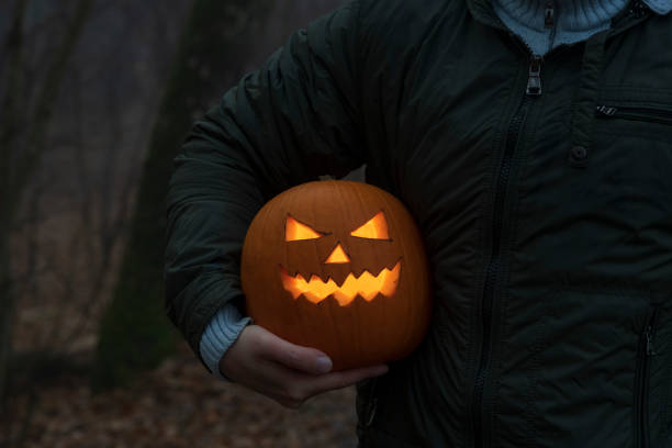istock Man holds Halloween pumpkin head under the arm 1350912390