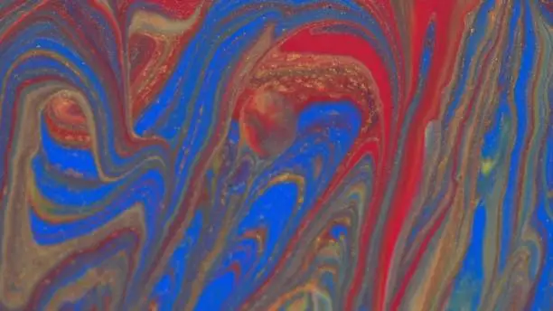 Abstract colorful background of spreading colors. Abstract red paint background. Acrylic texture with marble pattern. Abstract-ART. Natural luxury. The style includes the vortices of marble or the ripples. Very beautiful red, black, yellow, gray, blue paint with the addition of gold powder.