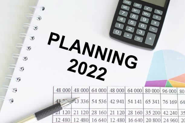 istock PLANNING 2022 text on the paper with calculator and notebook. Business concept 1350913227