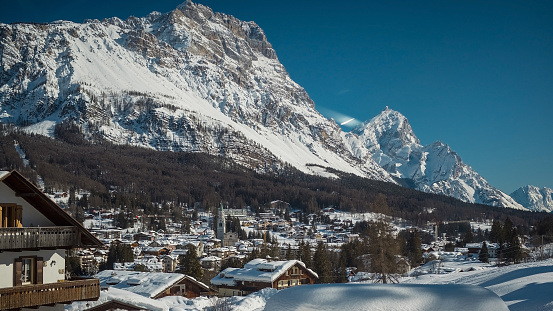 Sunny panorama of Cortina d'Ampezzo, a fancy and nice city or village in italian dolomites on a sunny winter day with a lot of snow.