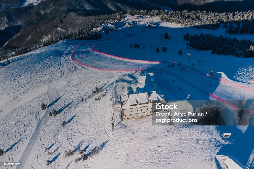 Aerial panorama of ski slope of Krvavec in Slovenia, visible also a ski race course between the red fence. Ski Stock Photo