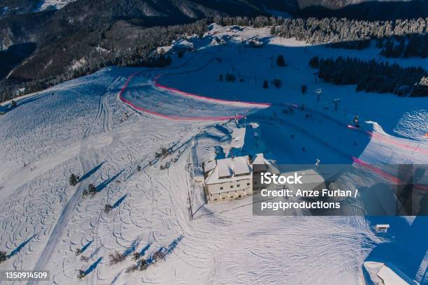 Aerial Panorama Of Ski Slope Of Krvavec In Slovenia Visible Also A Ski Race Course Between The Red Fence Stock Photo - Download Image Now