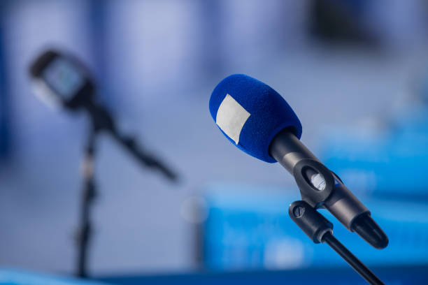 istock Professional wireless microphone on a microphone stand at a live event or interview area waiting for a person to come by. News radio area on an event. 1350915289