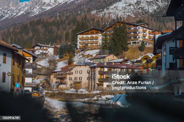 Houses And Hotels In Moena A City In Italian Val Di Fassa On A Sunny Winter Day Rising Over The River In The Centre Stock Photo - Download Image Now