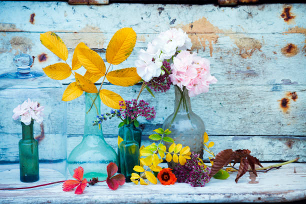 small miniature vases with flowers and leafs