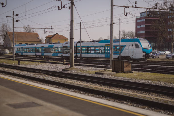 istock Modern blue and white passenger diesel train is resting on a siding at a train station waiting for next duties. 1350916865