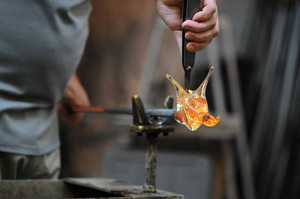 Glass Blower (Craftsperson) at work Glass Blower (Craftsperson) at work with Quartz glass. forming of Hot glowing quartz glass. hand blown glass stock pictures, royalty-free photos & images