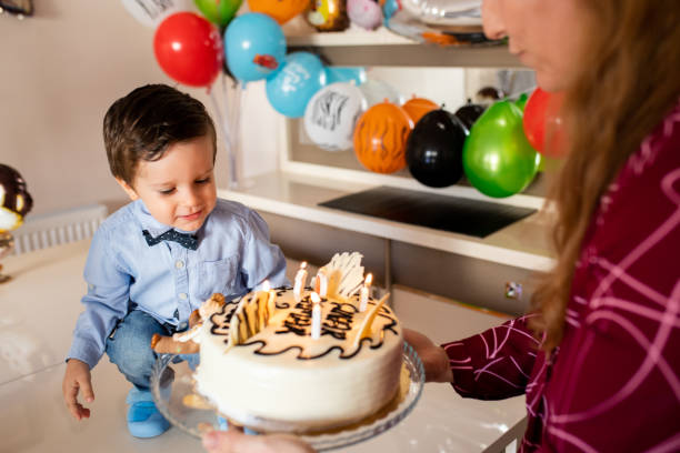 Little boy preparing for blowing out cake candle
