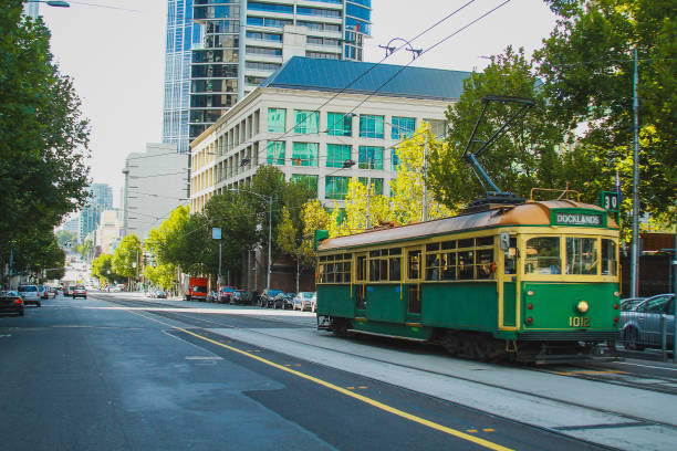 istock Vintage tram in Melbourne, Australia, rolling down the track in a modern district on a sunny day. 1350920722