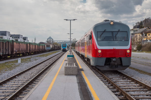 istock Old versus new passenger train standing on a platform. Concept of modernisation of rolling stock on railways. 1350923160