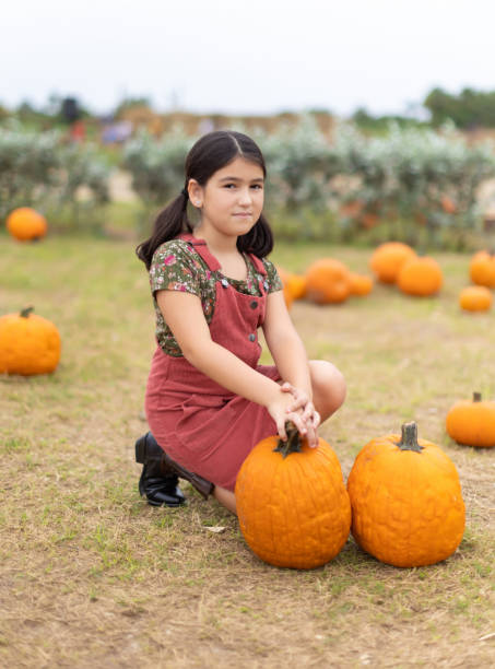istock Cuban little girl on pumpkin patch in Miami 1350923614
