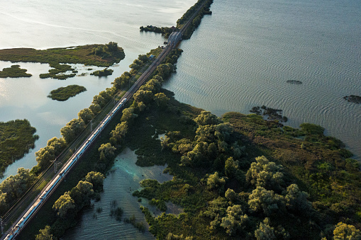 Aerial view of a train rides through the beautiful landscape