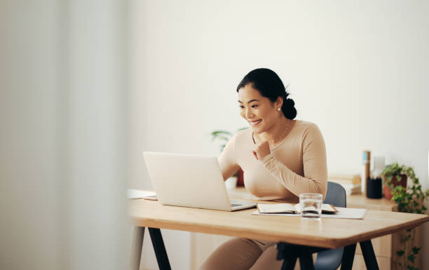 istock Cheerful Business Woman Working from Home on Laptop Computer 1350926537