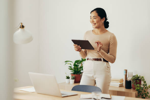 istock Beautiful Business Woman Using Digital Tablet at Home 1350926640